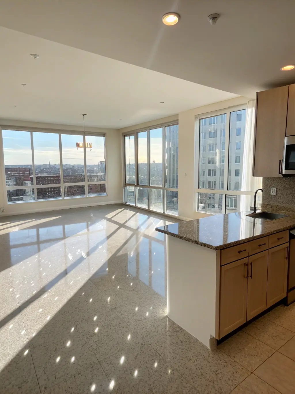 An empty apartment with sparkling clean floors and windows, ready for new occupants, demonstrating Elevated Clean Co.'s move-in/move-out cleaning service.